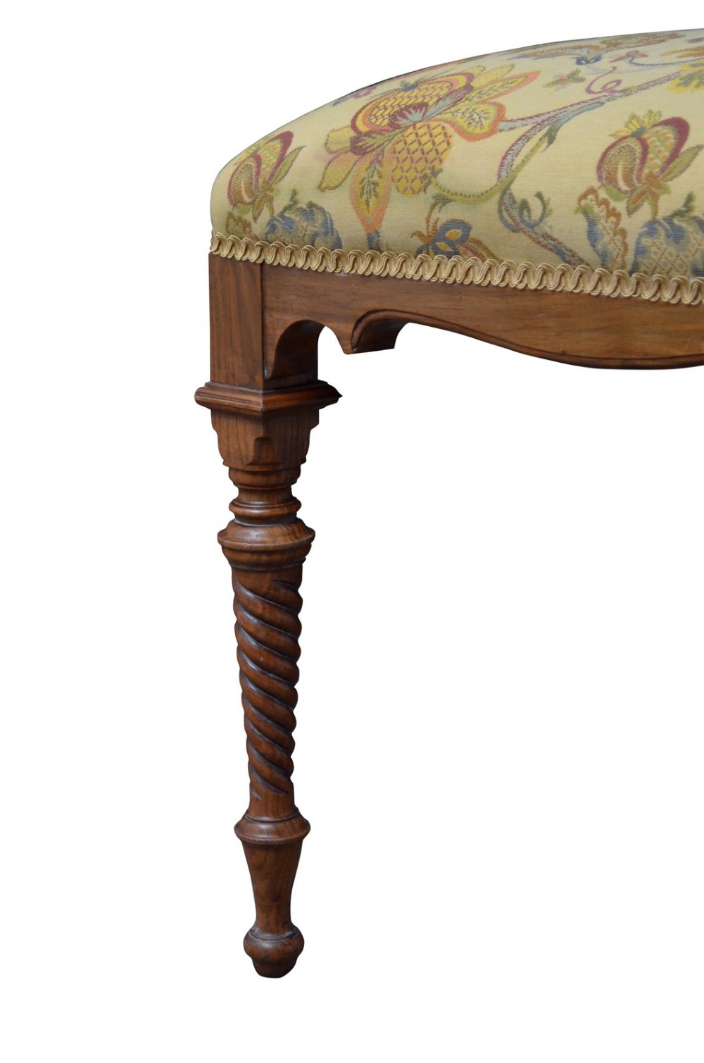 A walnut dressing table stool with turned barley twist legs and a padded seat upholstered in yellow floral patterned fabric. View V