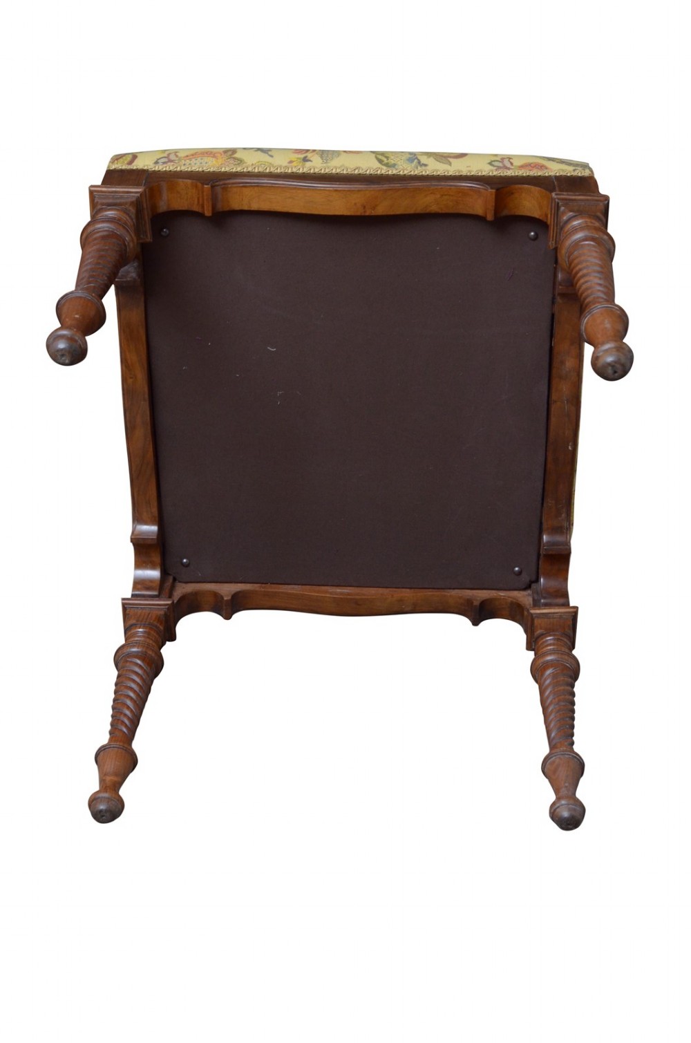 A walnut dressing table stool with turned barley twist legs and a padded seat upholstered in yellow floral patterned fabric. View IX