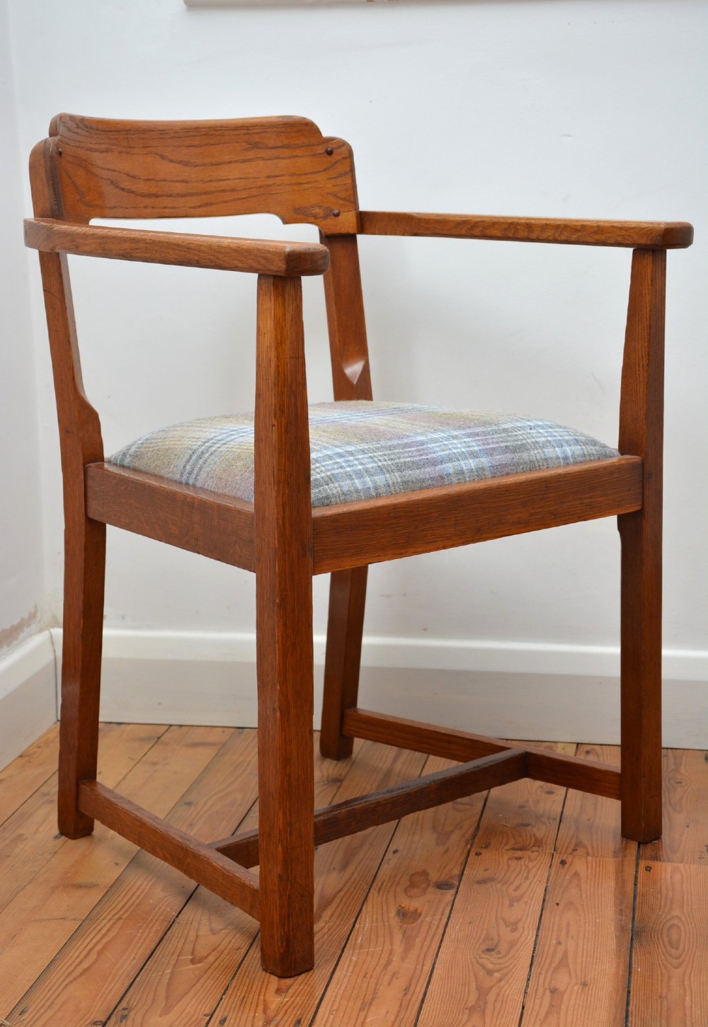 An oak Arts and Crafts desk chair featuring straight armrests, a rectangular backrest, and a blue and grey plaid upholstered seat. View VIII