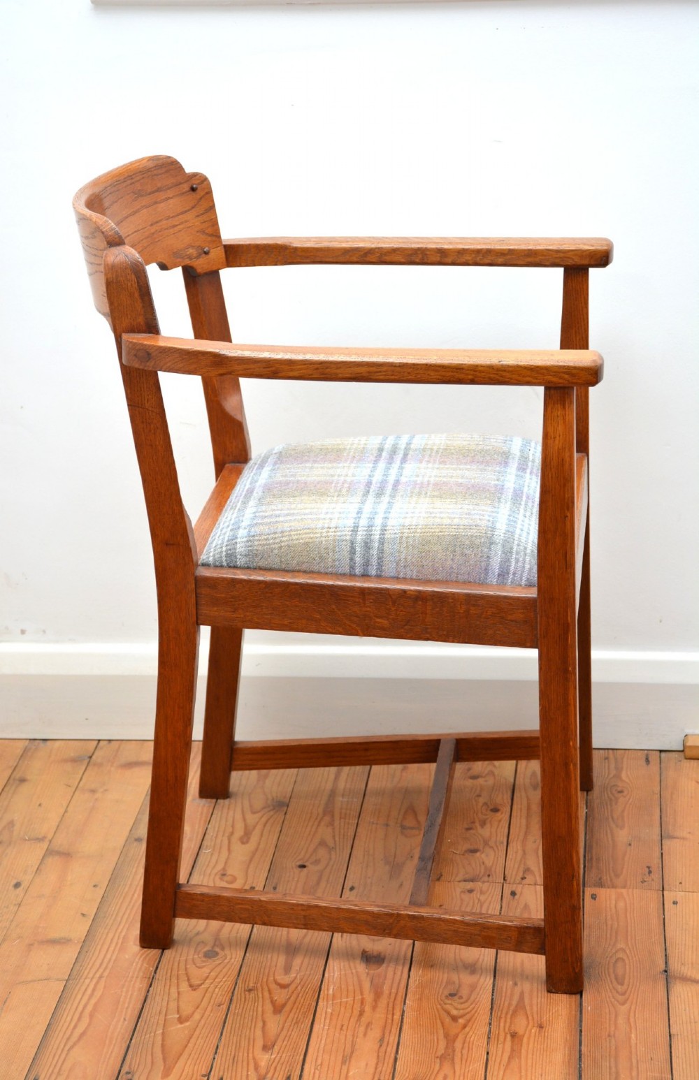An oak Arts and Crafts desk chair featuring straight armrests, a rectangular backrest, and a blue and grey plaid upholstered seat. View XI