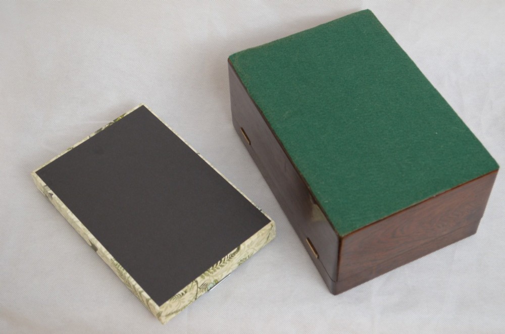 A rectangular dark rosewood jewellery box featuring brass foliate inlays and a central brass keyhole escutcheon. View III