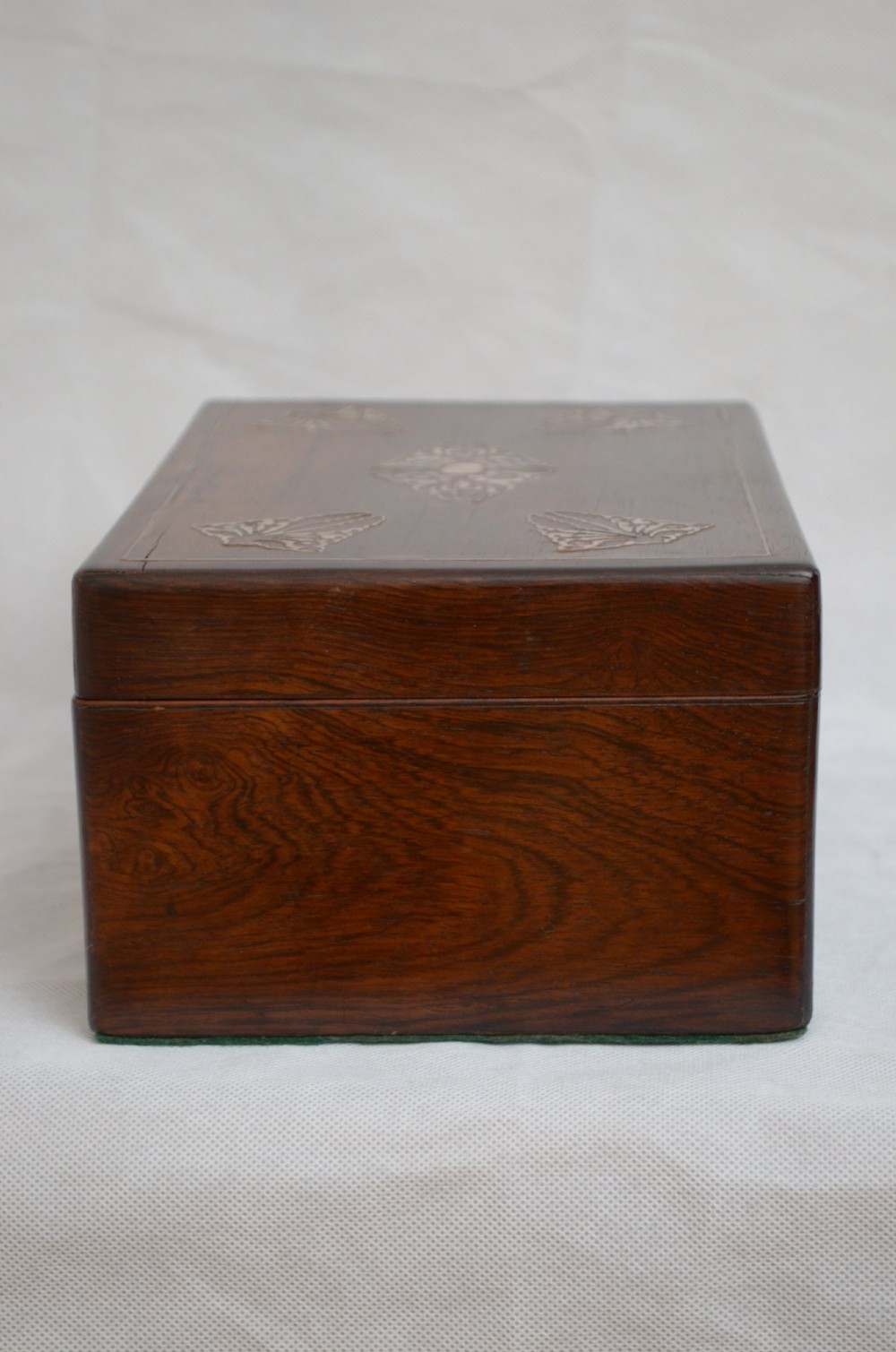 A rectangular dark rosewood jewellery box featuring brass foliate inlays and a central brass keyhole escutcheon. View XI