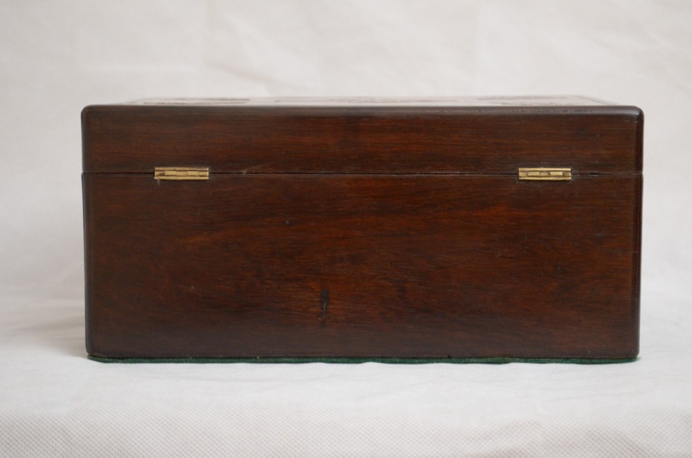 A rectangular dark rosewood jewellery box featuring brass foliate inlays and a central brass keyhole escutcheon. View XII