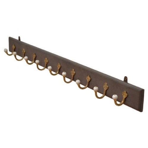 A long dark timber wall-mounted coat rack featuring multiple cast brass hooks with white ceramic finials.