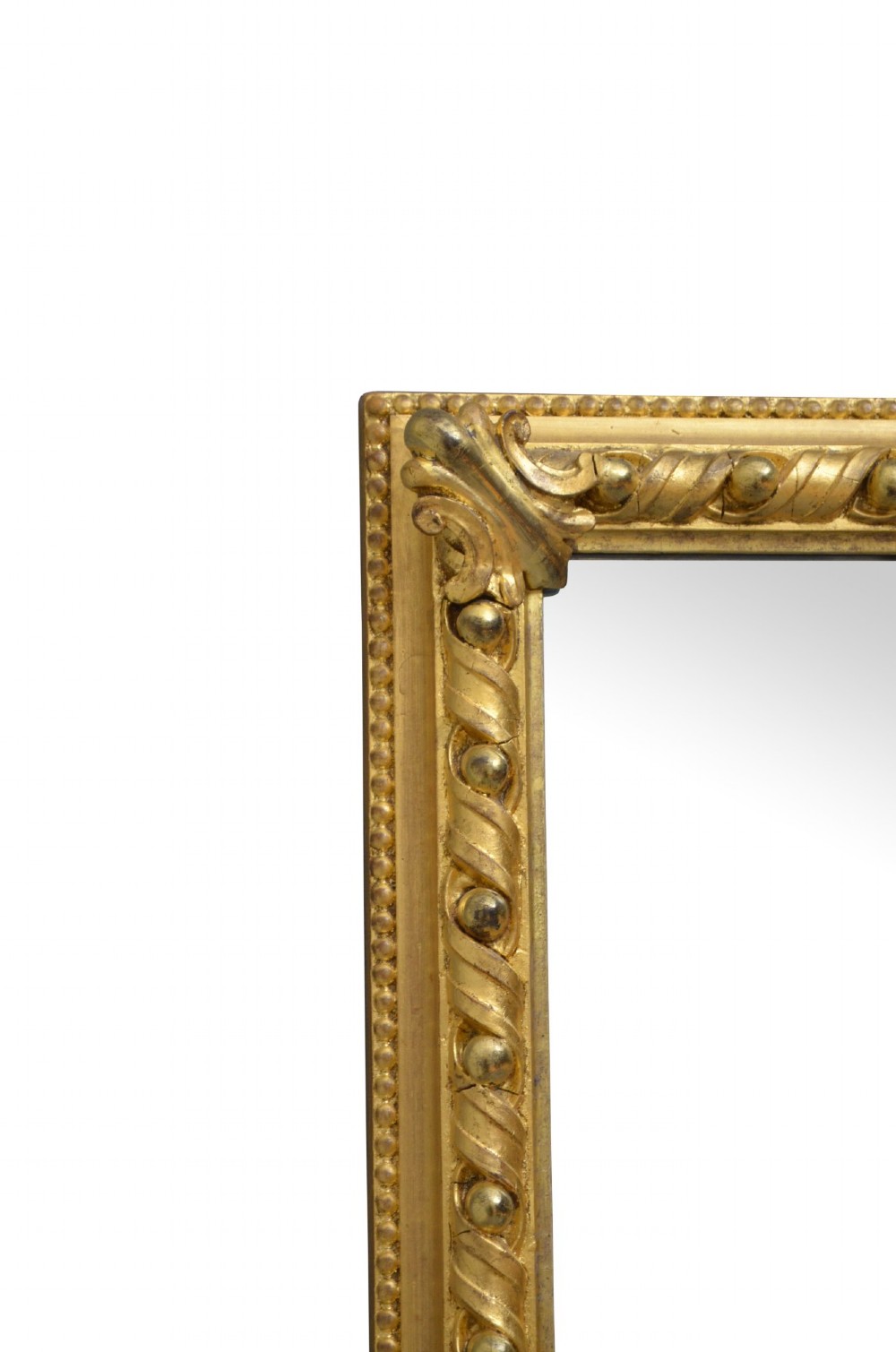 A rectangular antique overmantel mirror with a carved giltwood frame featuring rope-twist moulding, beaded edging, and scroll side feet. View VI