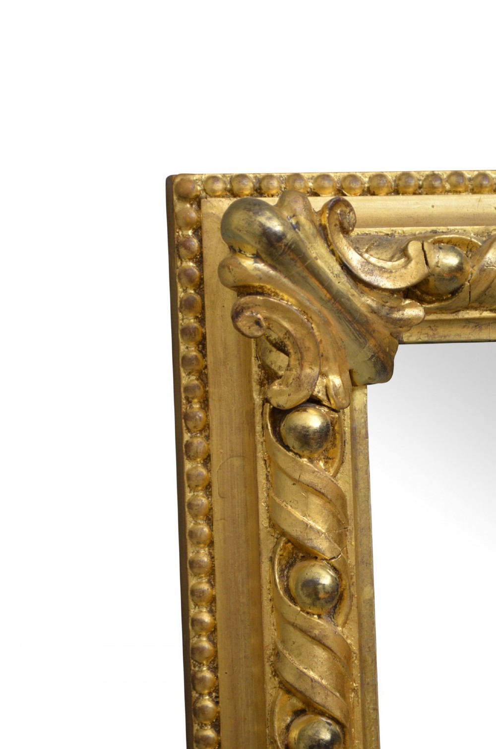 A rectangular antique overmantel mirror with a carved giltwood frame featuring rope-twist moulding, beaded edging, and scroll side feet. View VII