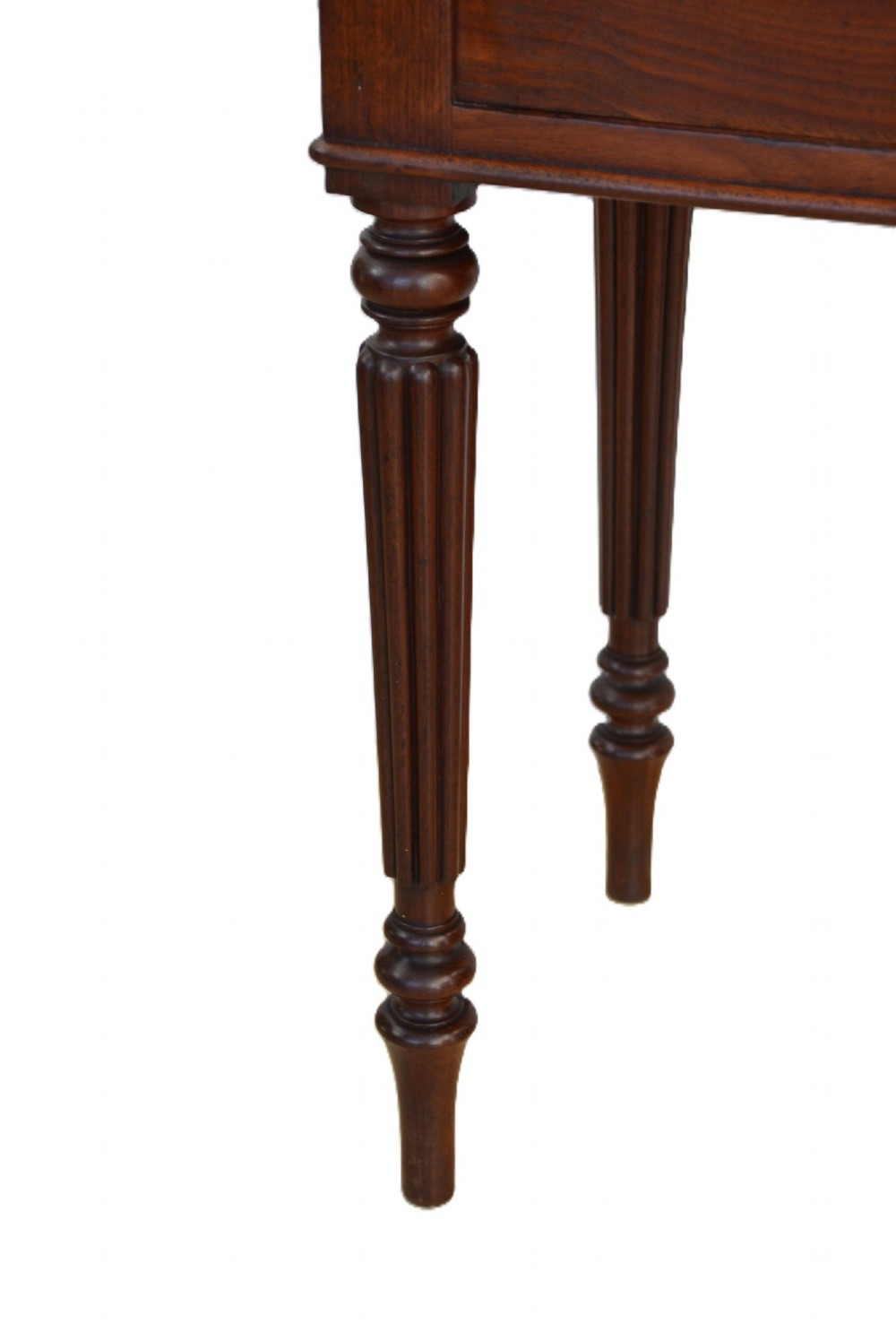 A dark mahogany bedside cabinet featuring a three-sided gallery top, a single door with a turned wooden knob, and four slender reeded legs. View XI