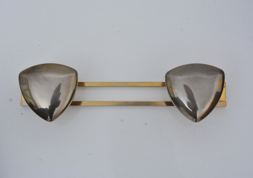 A set of two silver shield-shaped coat hooks mounted on a horizontal gold-toned metal wall bar. View XI