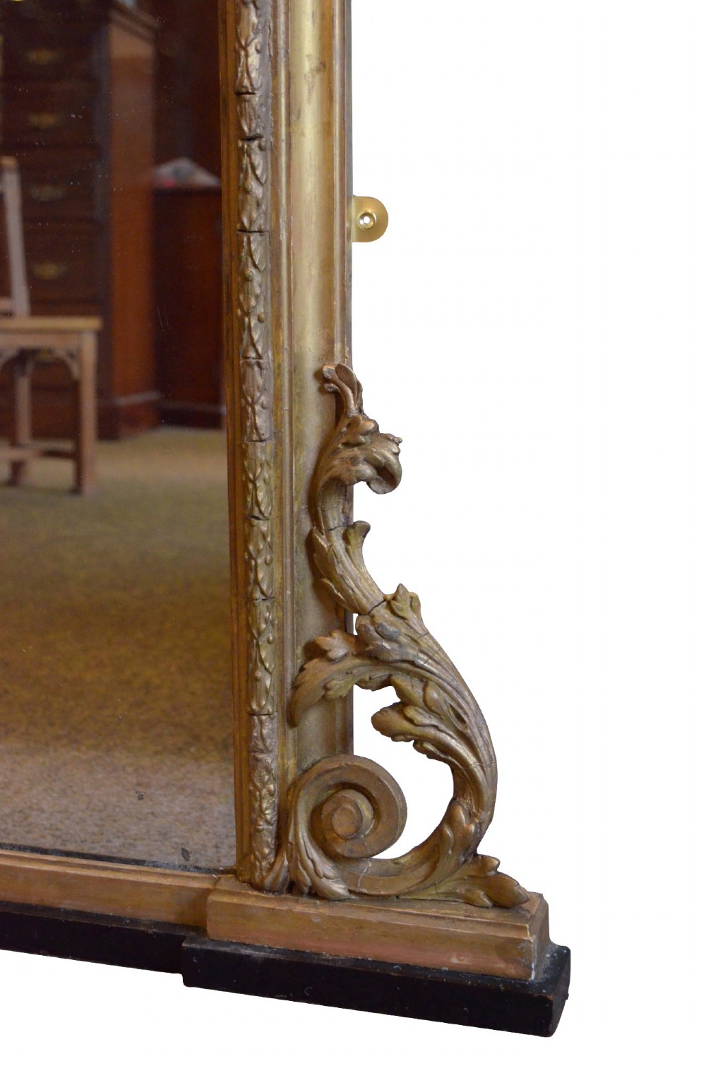 A large arched giltwood overmantel mirror featuring decorative floral moulding and side scroll details. View X