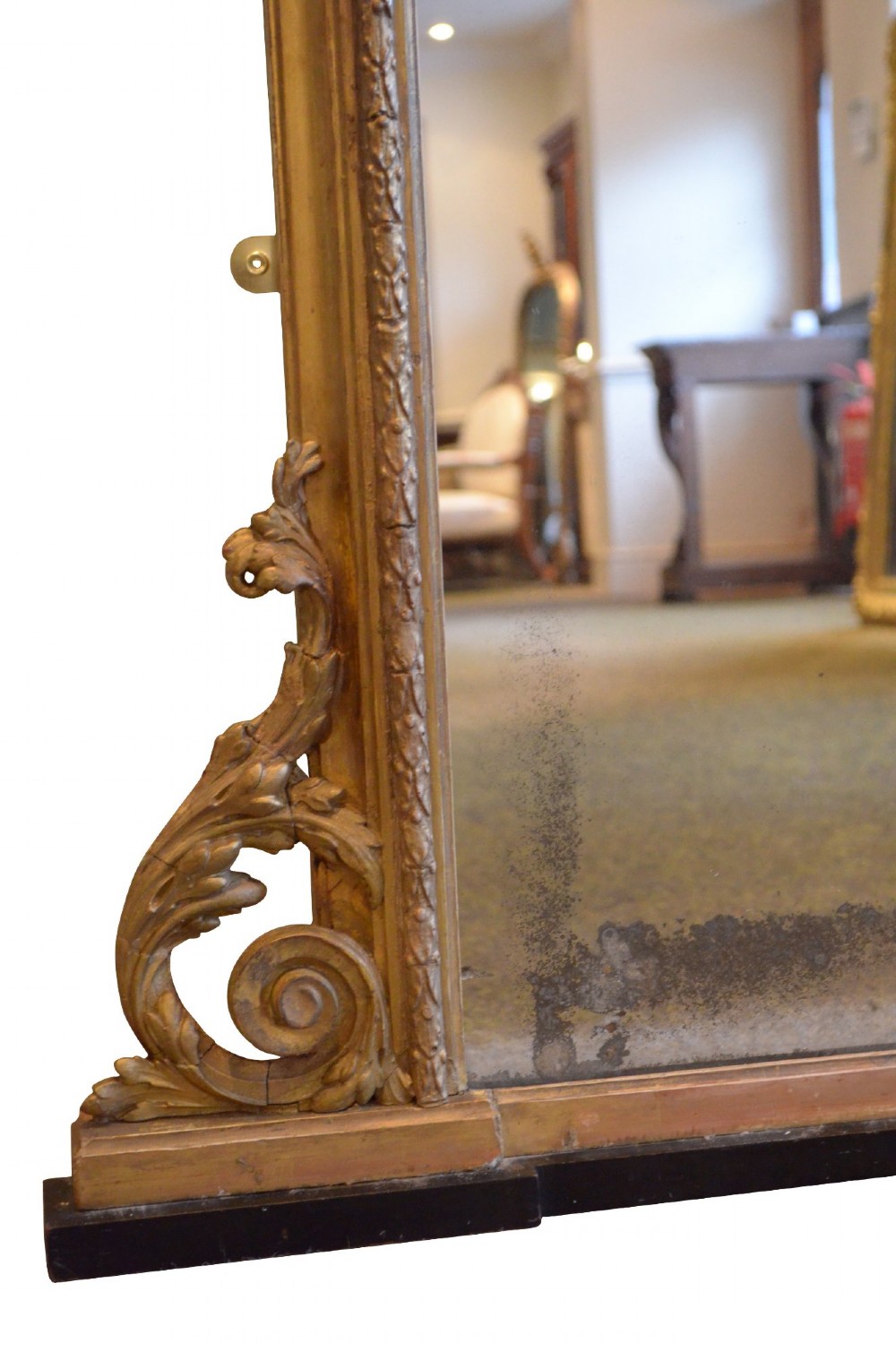 A large arched giltwood overmantel mirror featuring decorative floral moulding and side scroll details. View XIV