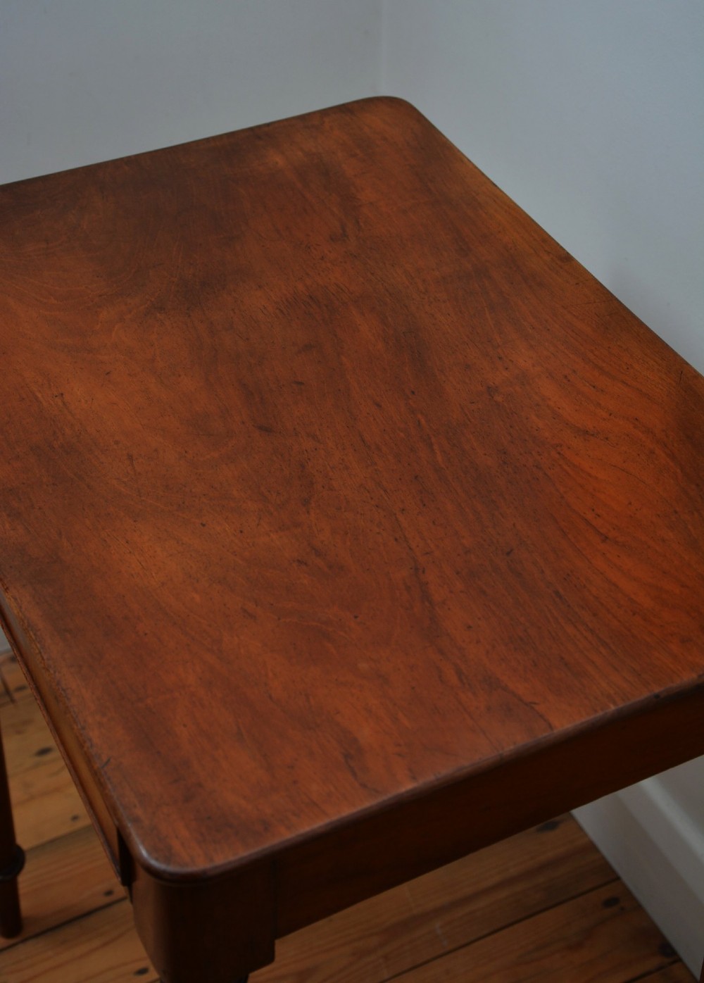 An English William IV mahogany side table featuring a single frieze drawer with a turned wooden knob handle and slim turned legs. View VI