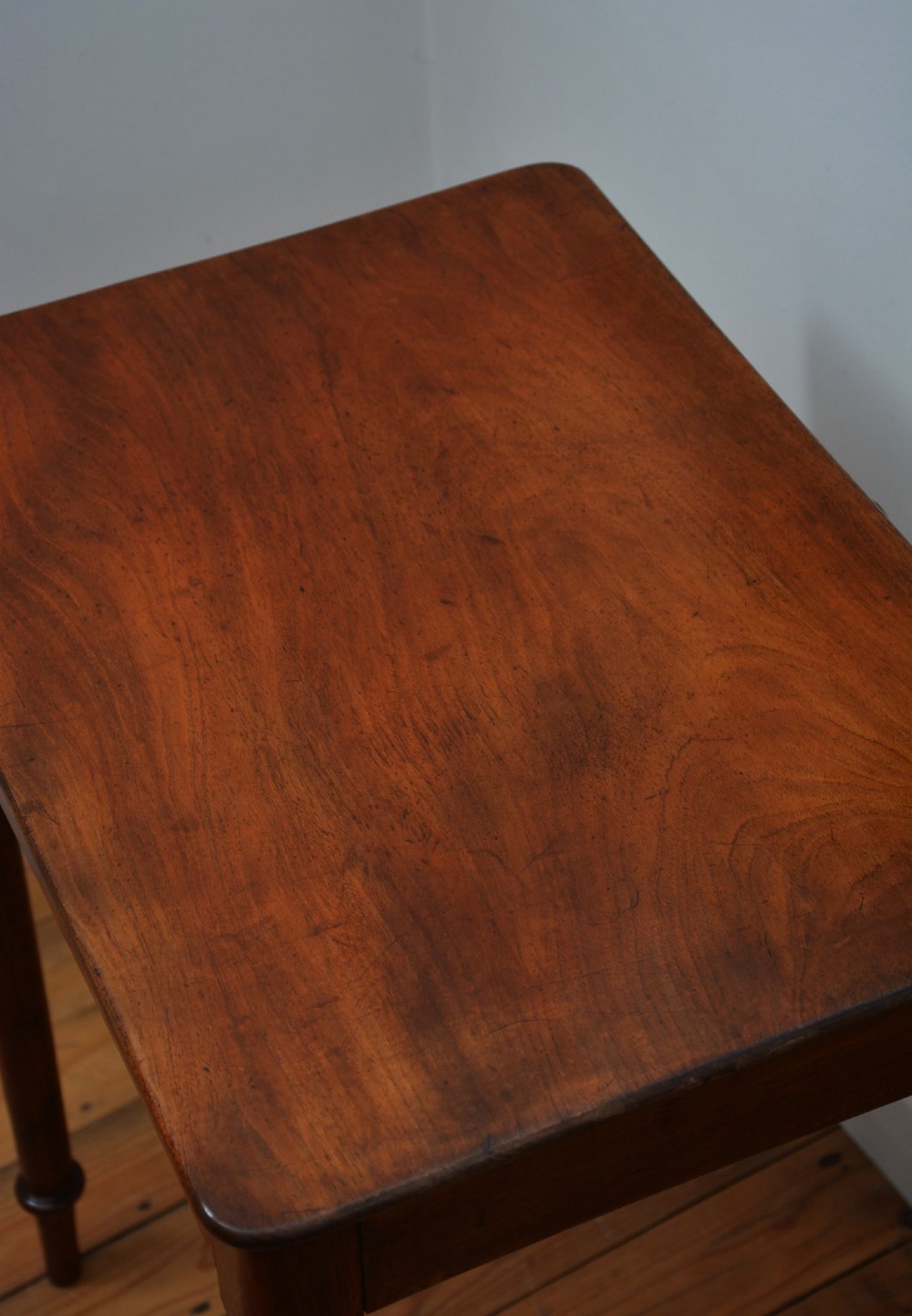 An English William IV mahogany side table featuring a single frieze drawer with a turned wooden knob handle and slim turned legs. View VII
