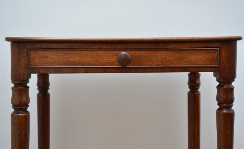An English William IV mahogany side table featuring a single frieze drawer with a turned wooden knob handle and slim turned legs. View VIII