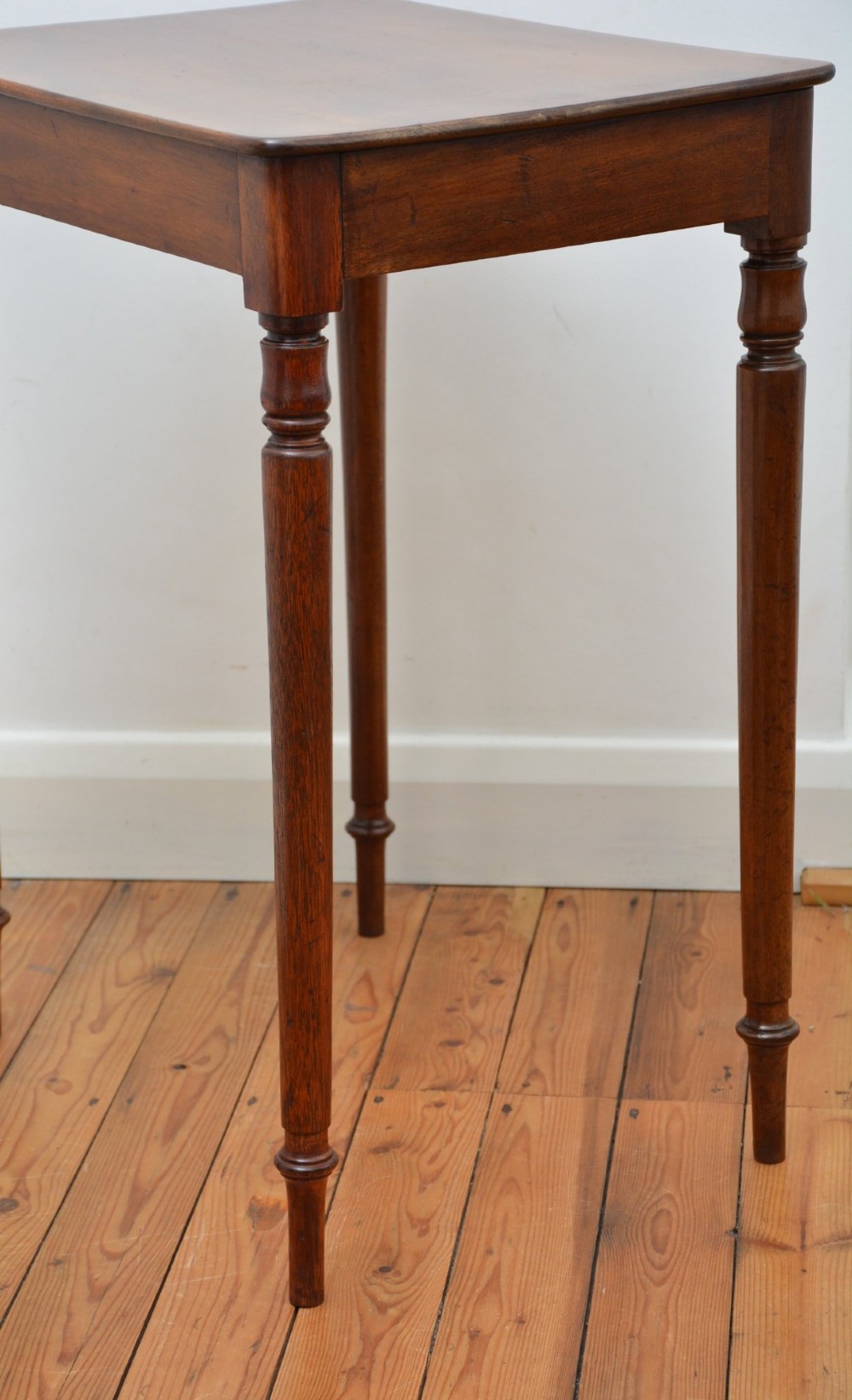 An English William IV mahogany side table featuring a single frieze drawer with a turned wooden knob handle and slim turned legs. View XI