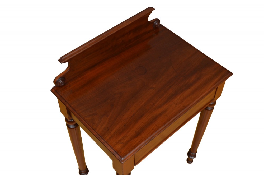 A Victorian mahogany hall table featuring a gallery back upstand, a single frieze drawer, and four turned legs. View IV