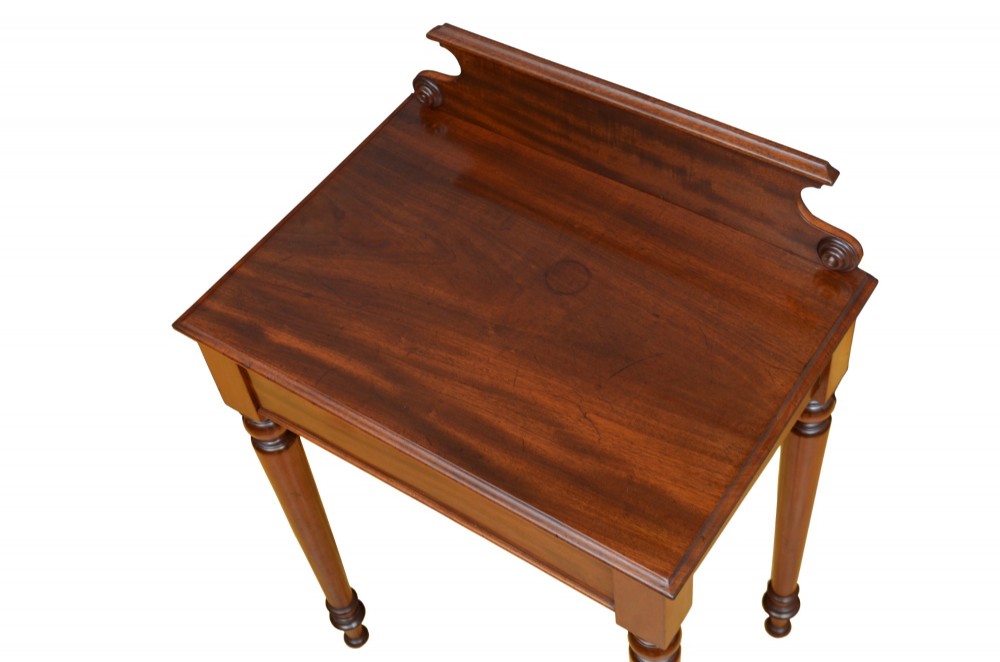 A Victorian mahogany hall table featuring a gallery back upstand, a single frieze drawer, and four turned legs. View V