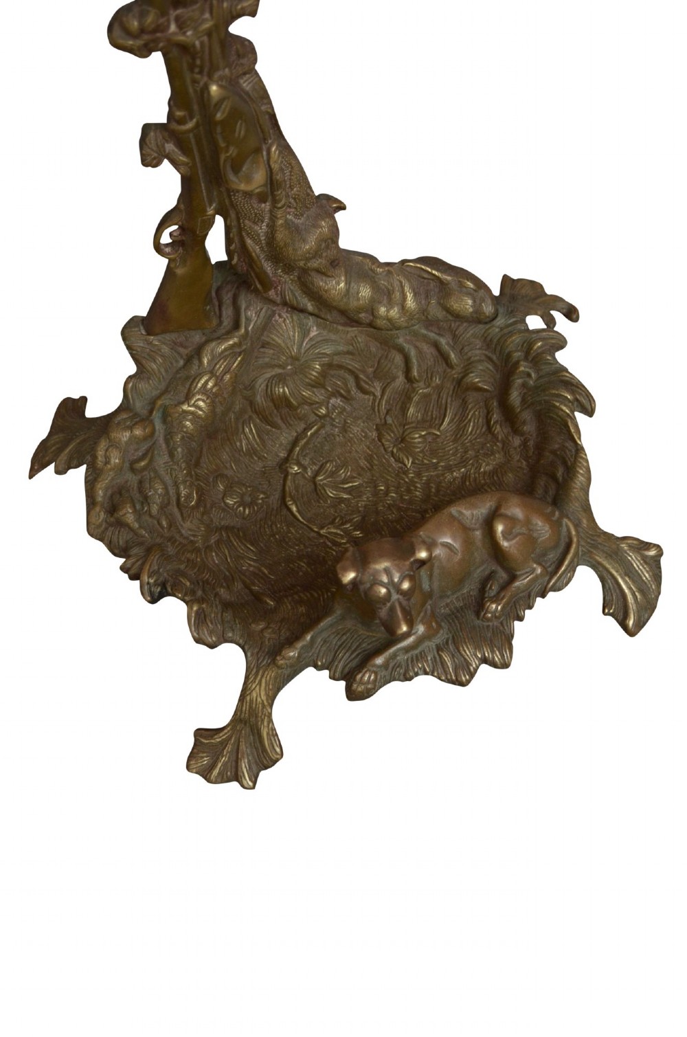 An antique cast brass stick stand featuring sporting motifs including a resting hound, rifle, game bag, and hunting horn. View VII
