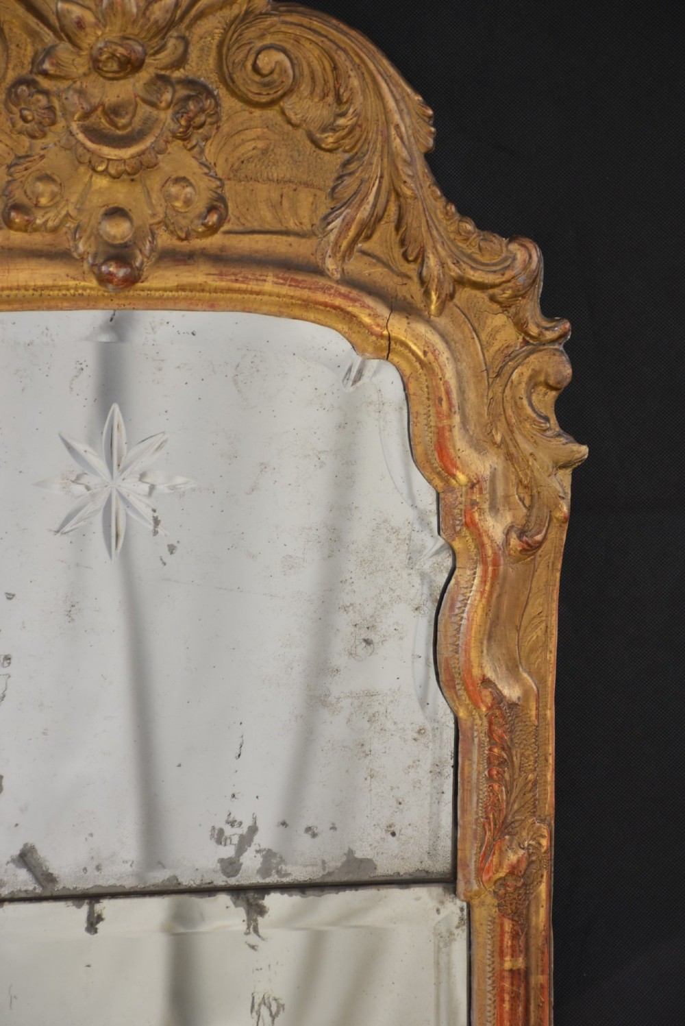 A tall, narrow Georgian giltwood pier mirror featuring a carved shell crest, scrollwork frame, and a split glass mirror plate. View II