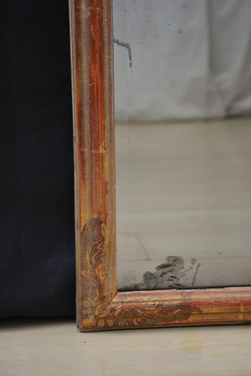 A tall, narrow Georgian giltwood pier mirror featuring a carved shell crest, scrollwork frame, and a split glass mirror plate. View VIII