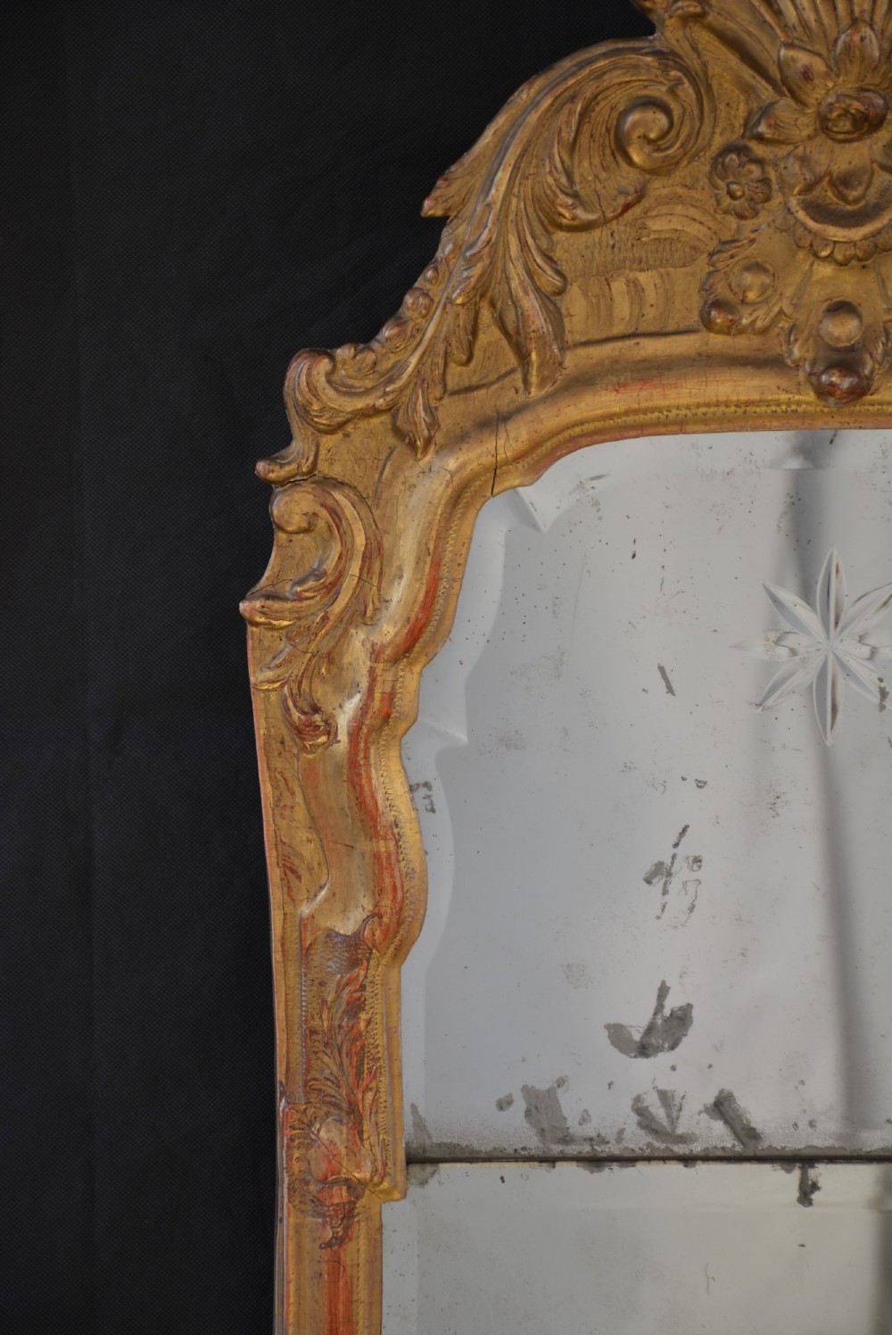 A tall, narrow Georgian giltwood pier mirror featuring a carved shell crest, scrollwork frame, and a split glass mirror plate. View X