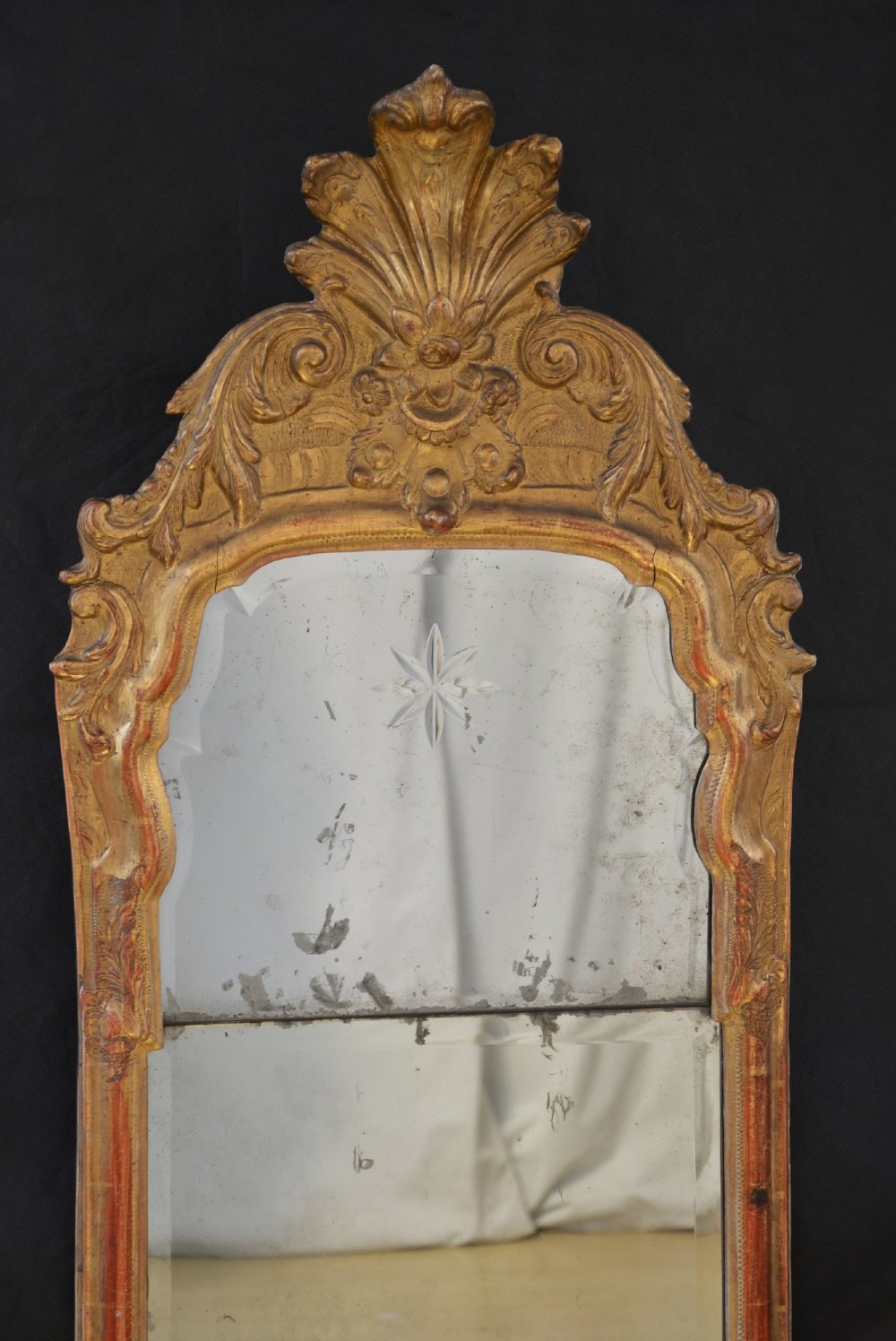 A tall, narrow Georgian giltwood pier mirror featuring a carved shell crest, scrollwork frame, and a split glass mirror plate. View XI