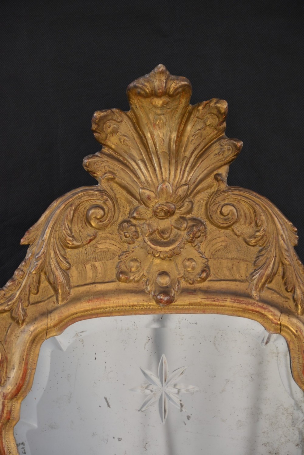A tall, narrow Georgian giltwood pier mirror featuring a carved shell crest, scrollwork frame, and a split glass mirror plate. View XII