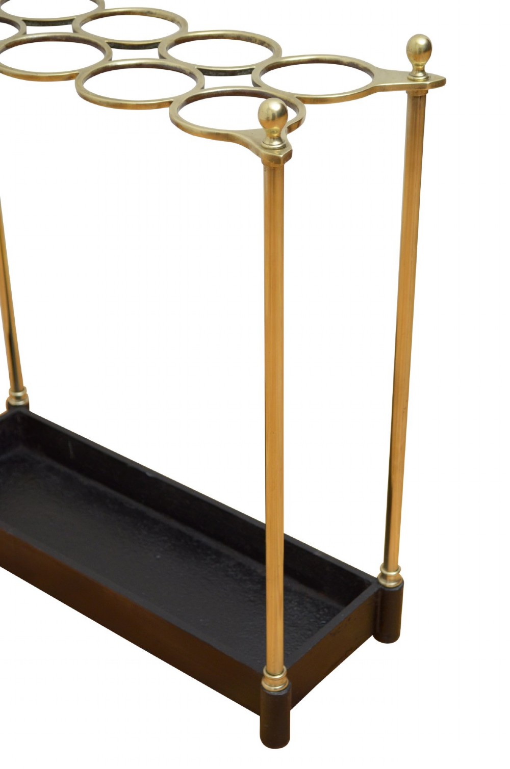 A Victorian brass umbrella stand featuring an eight-ring top frame, four tubular posts with ball finials, and a rectangular black cast iron drip tray. View IV