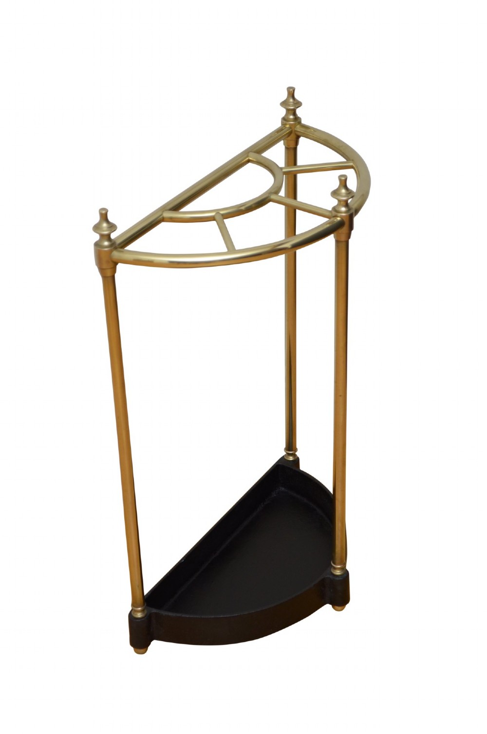 A semi-circular brass umbrella stand featuring vertical tubular supports, decorative finials, top divisions, and a black cast-iron drip tray base. View II