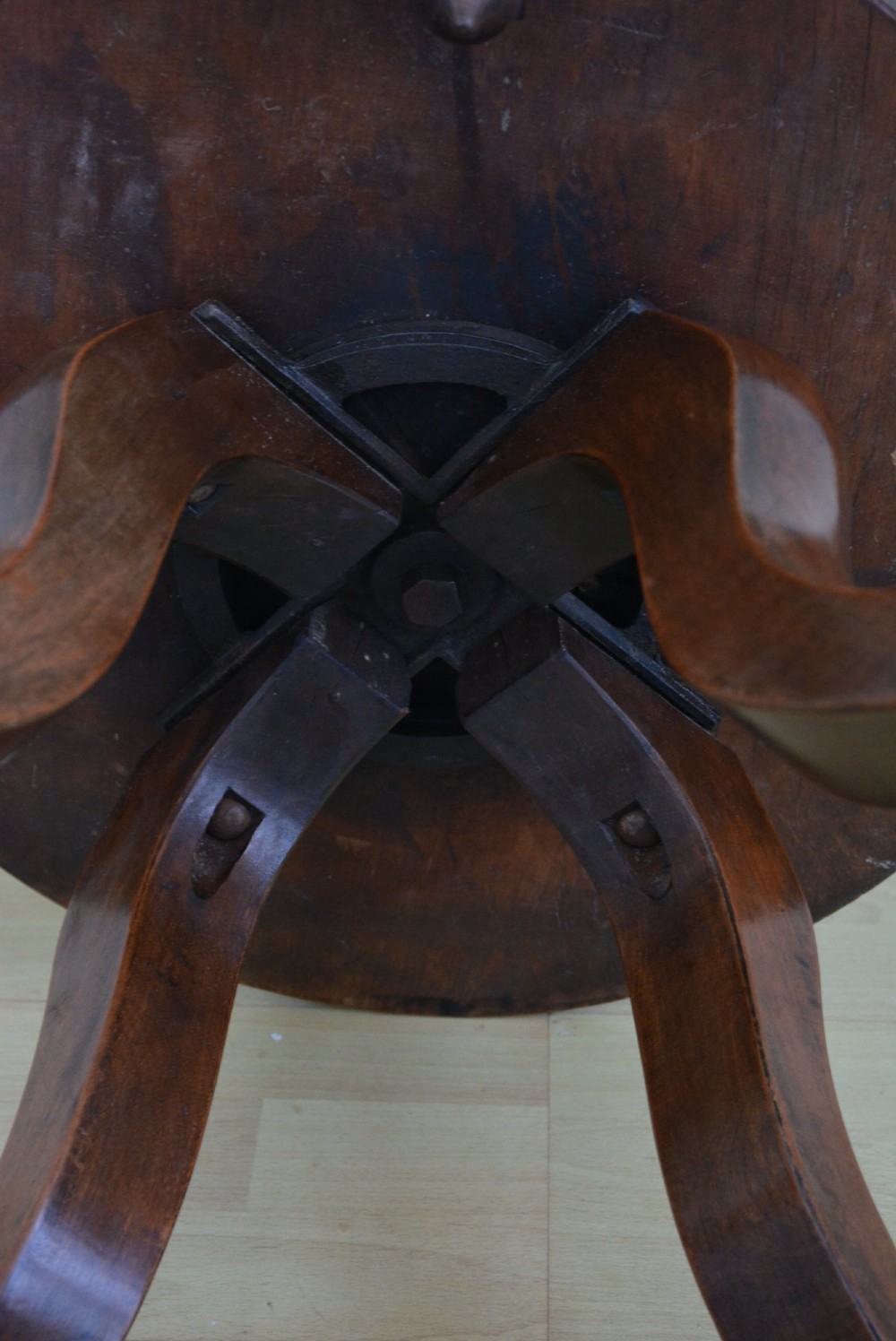 An antique walnut revolving desk chair featuring a curved horseshoe backrest with turned spindles, a circular wooden seat, and four splayed legs on castors. View XI