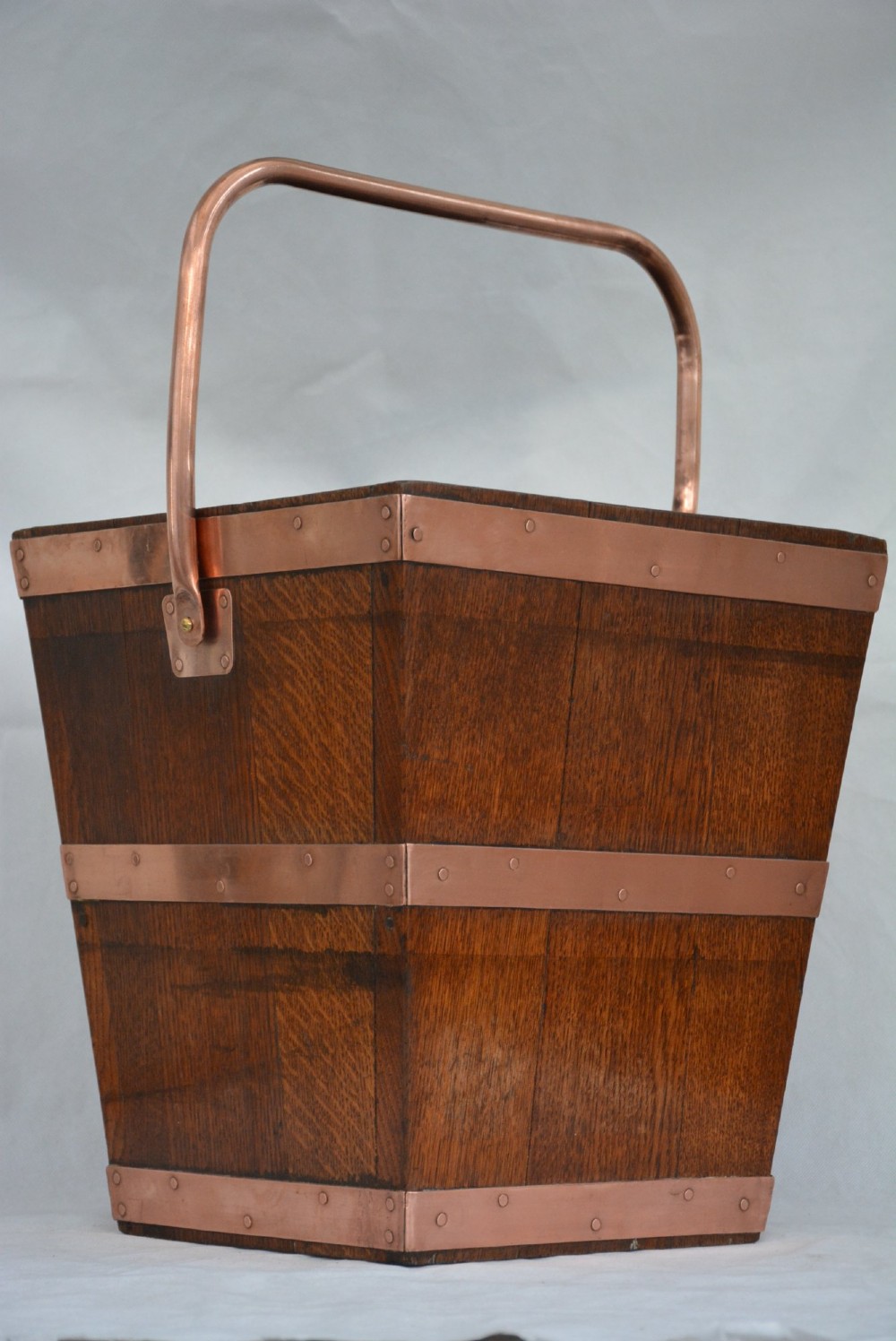 A tapered dark oak wooden coal bucket bound with copper straps and featuring a copper swing handle. View III