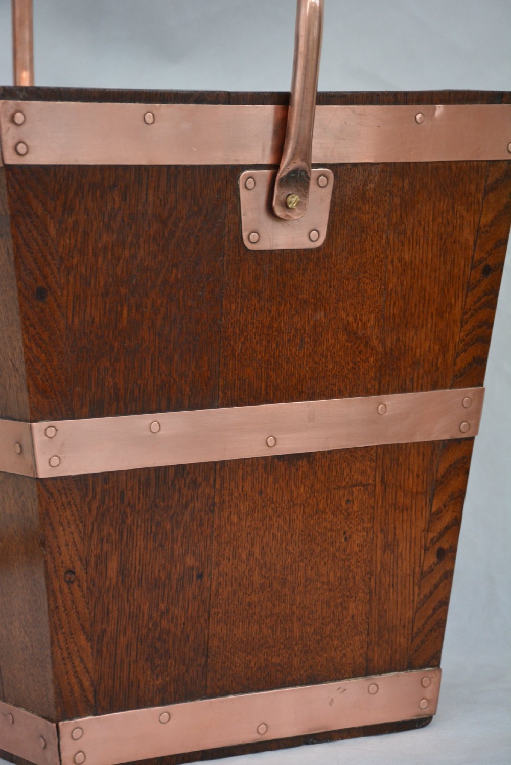 A tapered dark oak wooden coal bucket bound with copper straps and featuring a copper swing handle. View VI