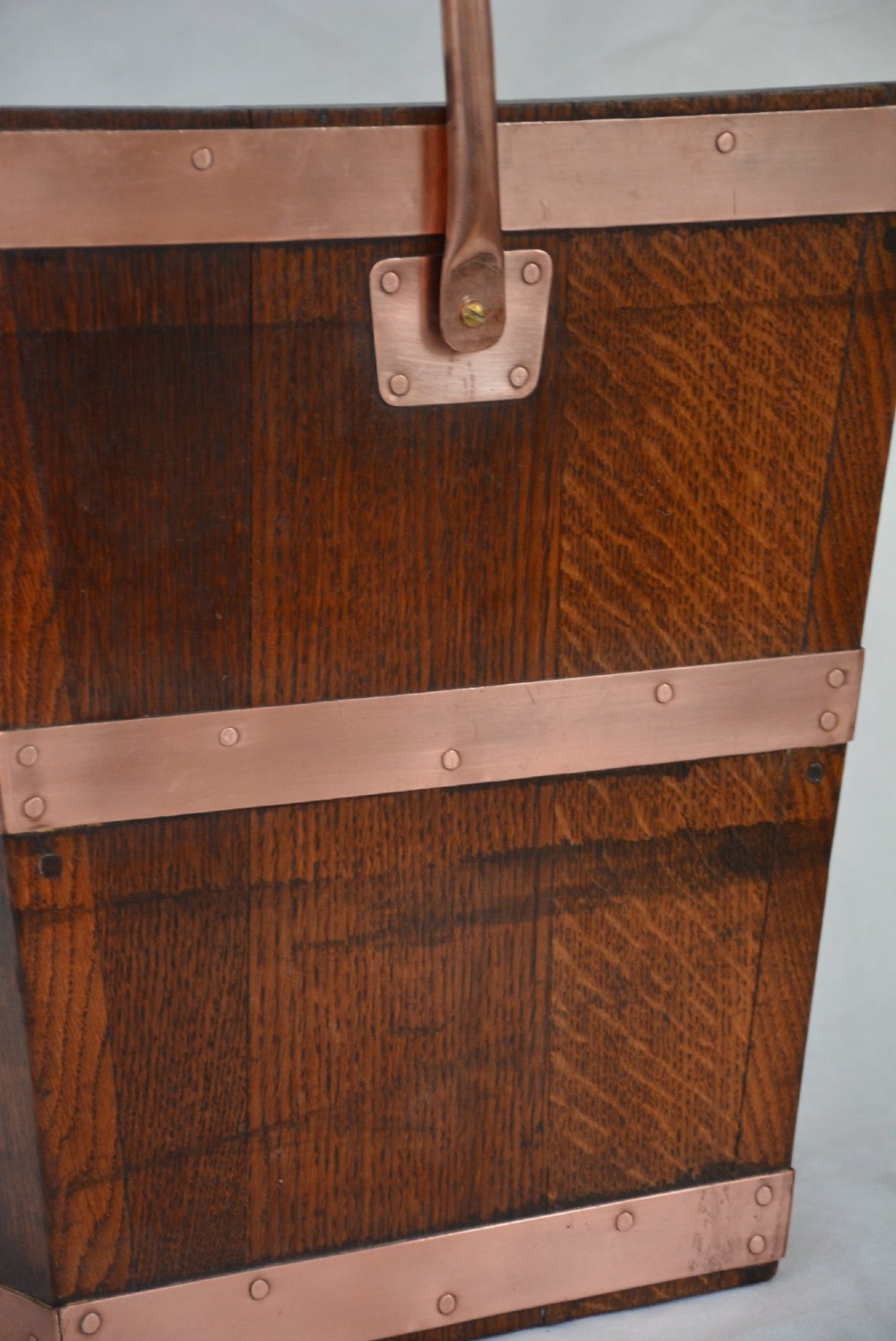 A tapered dark oak wooden coal bucket bound with copper straps and featuring a copper swing handle. View VIII