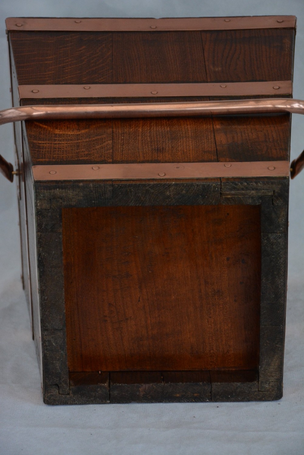 A tapered dark oak wooden coal bucket bound with copper straps and featuring a copper swing handle. View XII