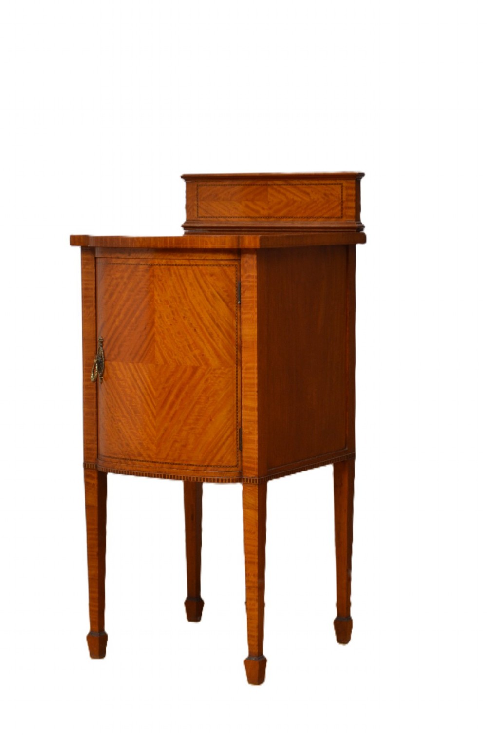 An Edwardian satinwood bedside cabinet with a gallery upstand top, diamond-patterned veneered cupboard door, and square tapered legs. View II