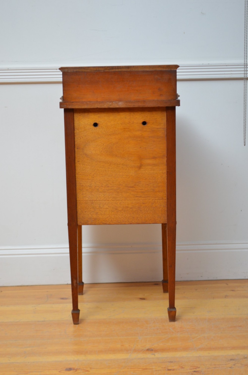 An Edwardian satinwood bedside cabinet with a gallery upstand top, diamond-patterned veneered cupboard door, and square tapered legs. View XII