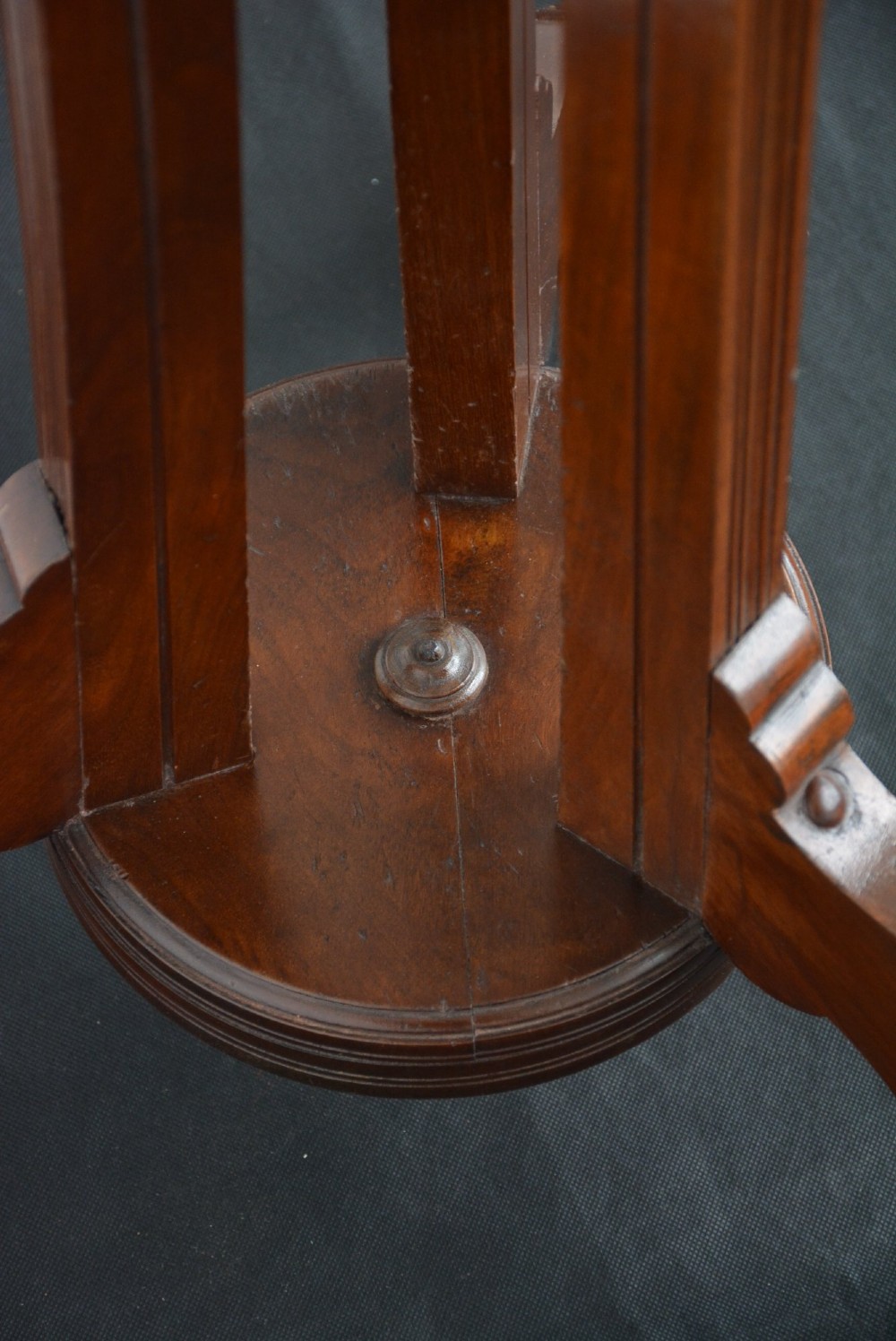 A tall freestanding dark walnut coat stand featuring a slatted central column, brass hooks, a turned finial, and four splayed feet. View II