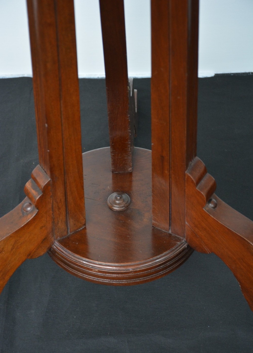 A tall freestanding dark walnut coat stand featuring a slatted central column, brass hooks, a turned finial, and four splayed feet. View XII