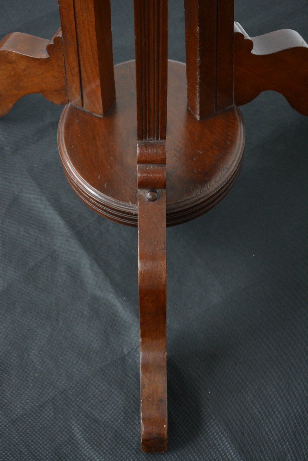 A tall freestanding dark walnut coat stand featuring a slatted central column, brass hooks, a turned finial, and four splayed feet. View XIII