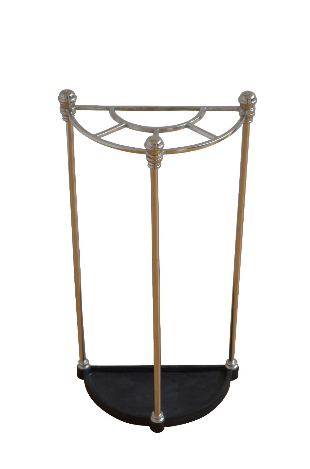 An Art Deco semi-circular nickel-plated umbrella stand featuring a fan-divided top section, three vertical support rods, and a black cast iron drip tray base.