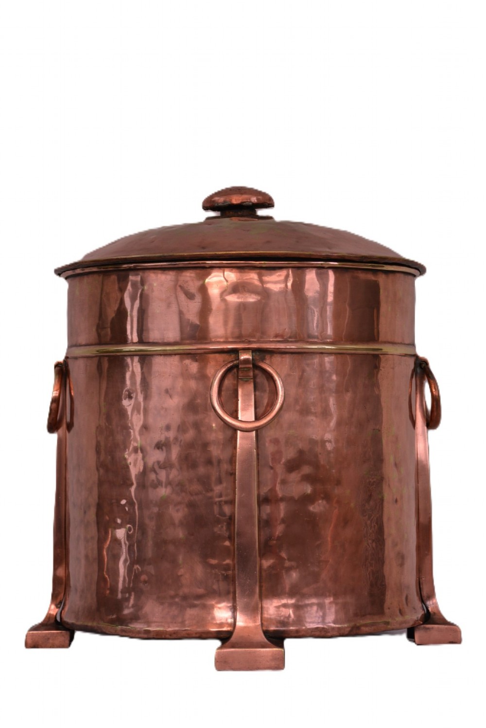 An Arts and Crafts hammered copper cylindrical coal bin featuring a fitted lid, drop side ring handles, structural legs, and a removable metal liner. View IV