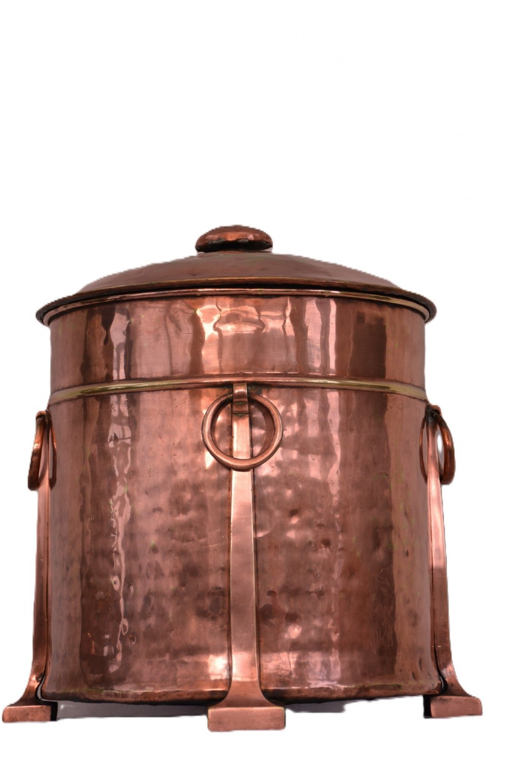 An Arts and Crafts hammered copper cylindrical coal bin featuring a fitted lid, drop side ring handles, structural legs, and a removable metal liner. View V