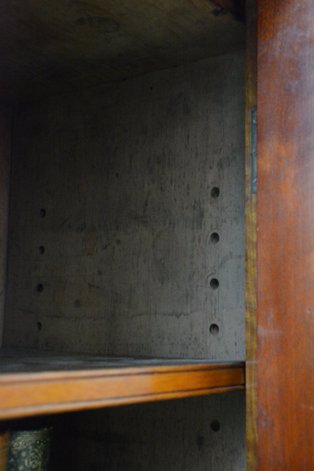 An English Victorian low bookcase made of figured walnut with two arched glass doors, carved corbels, and internal shelves. View XIV