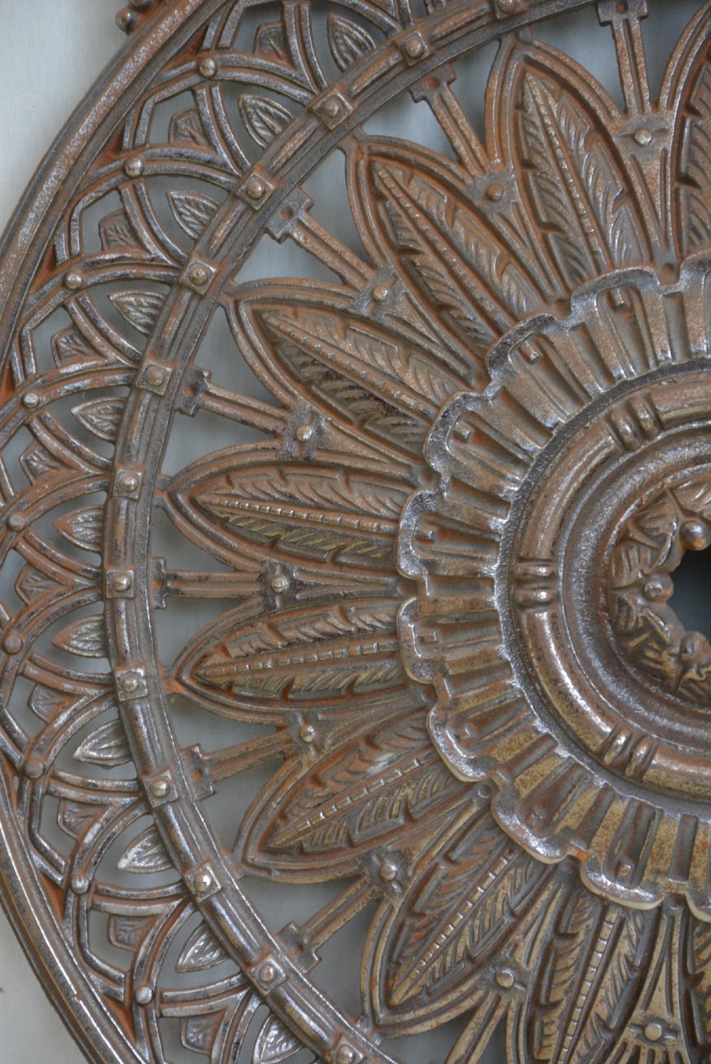 A circular Victorian cast iron ceiling rose featuring central feather relief detail surrounded by pierced openwork and ivy leaf border lugs. View XI