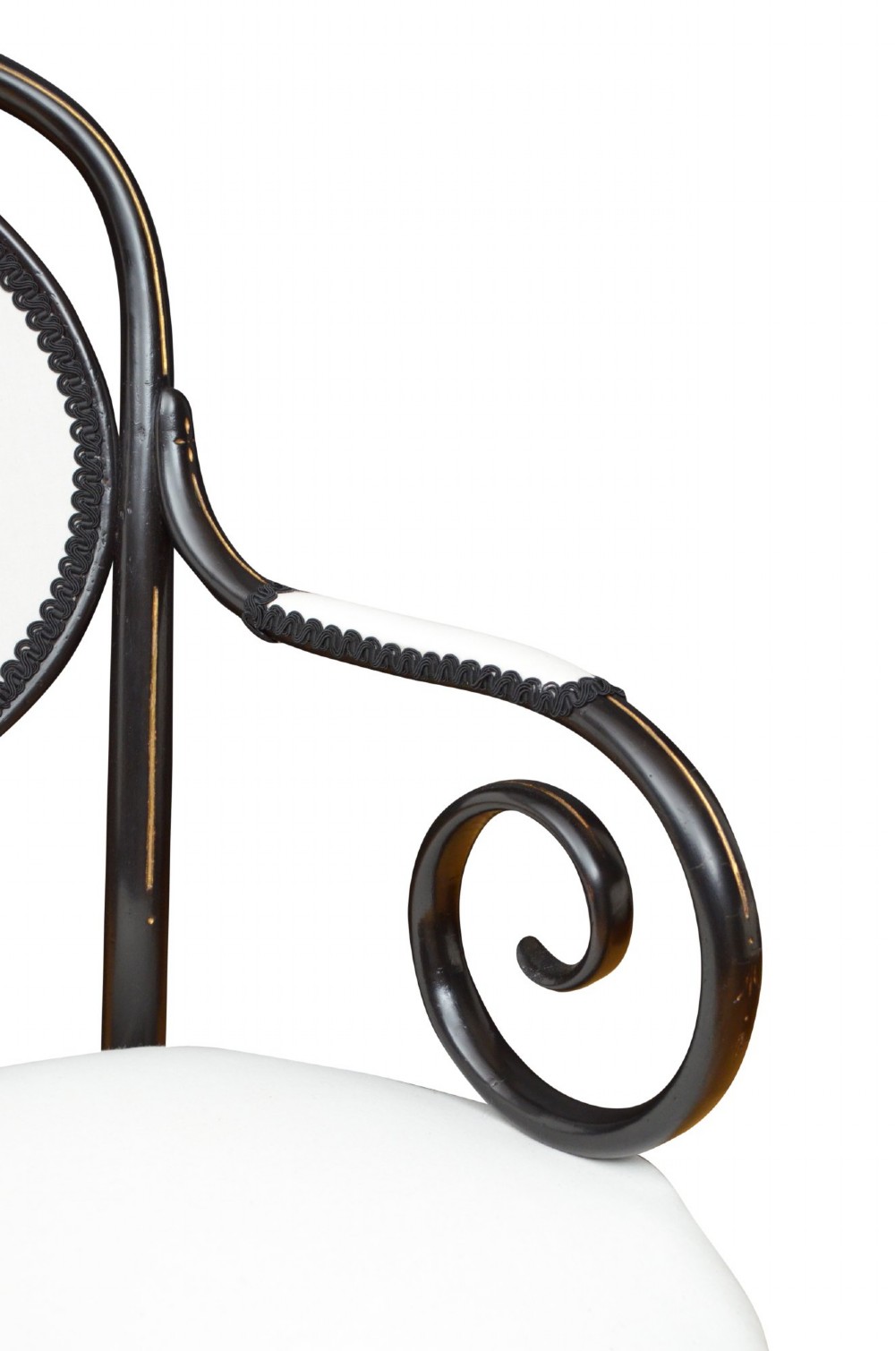An ebonised bentwood armchair featuring white upholstered seat and back panels, scrolled armrests, and gold linear detailing on a black wooden frame. View IX