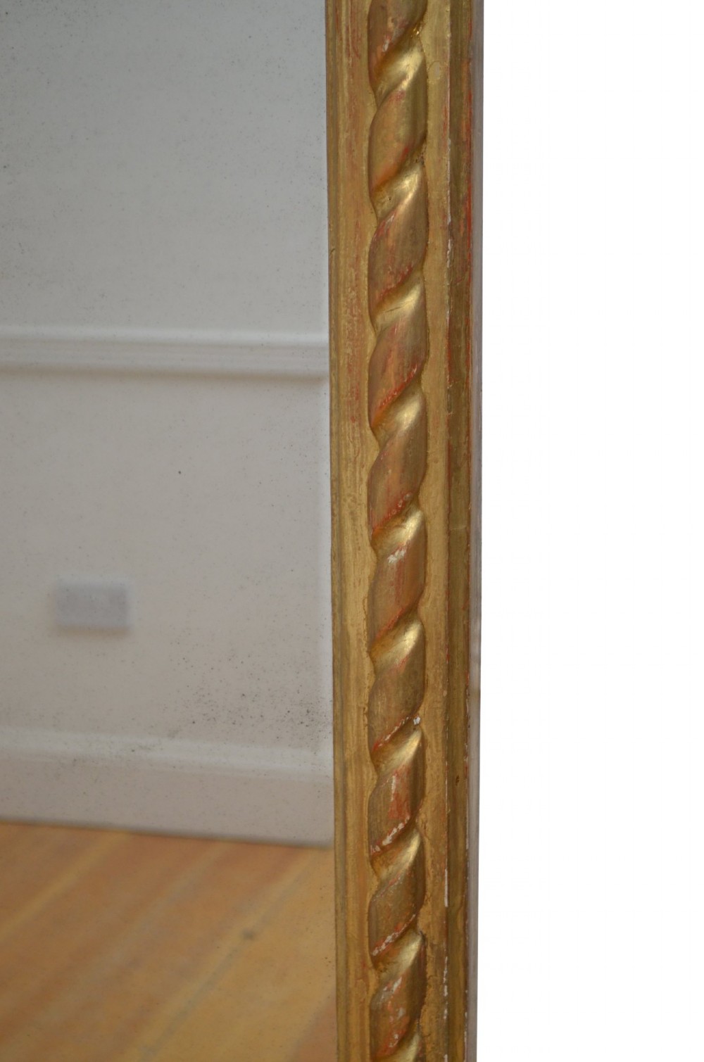 A tall nineteenth-century arched mirror featuring a gilded frame with a continuous carved rope twist motif. View II