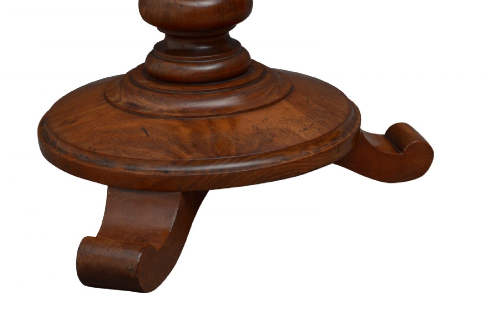 A William IV mahogany circular lamp table featuring a dark blue gilt-tooled leather inset top supported by a turned pedestal stem on a tri-form scroll-foot base. View III