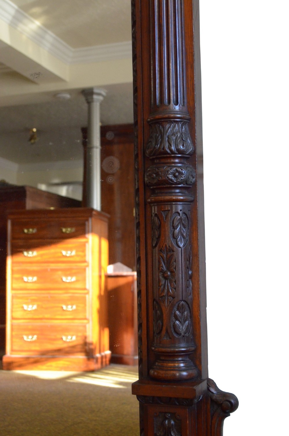 A tall 19th-century English solid oak mirror featuring an arched top, fluted column sides, and detailed hand-carved woodwork. View II