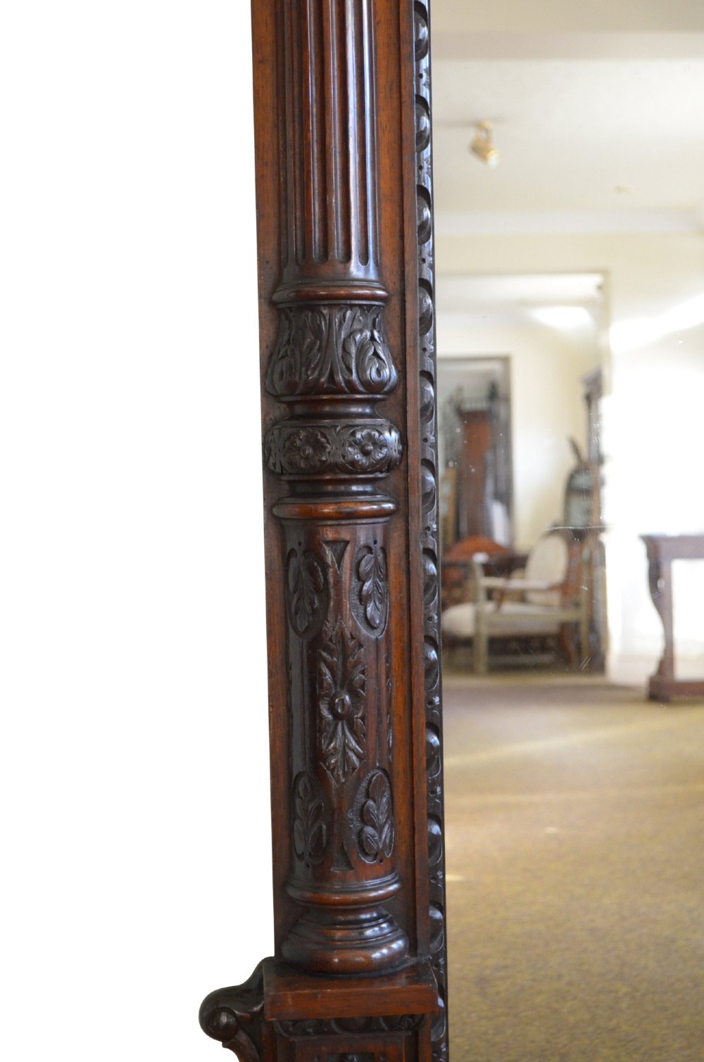 A tall 19th-century English solid oak mirror featuring an arched top, fluted column sides, and detailed hand-carved woodwork. View VII