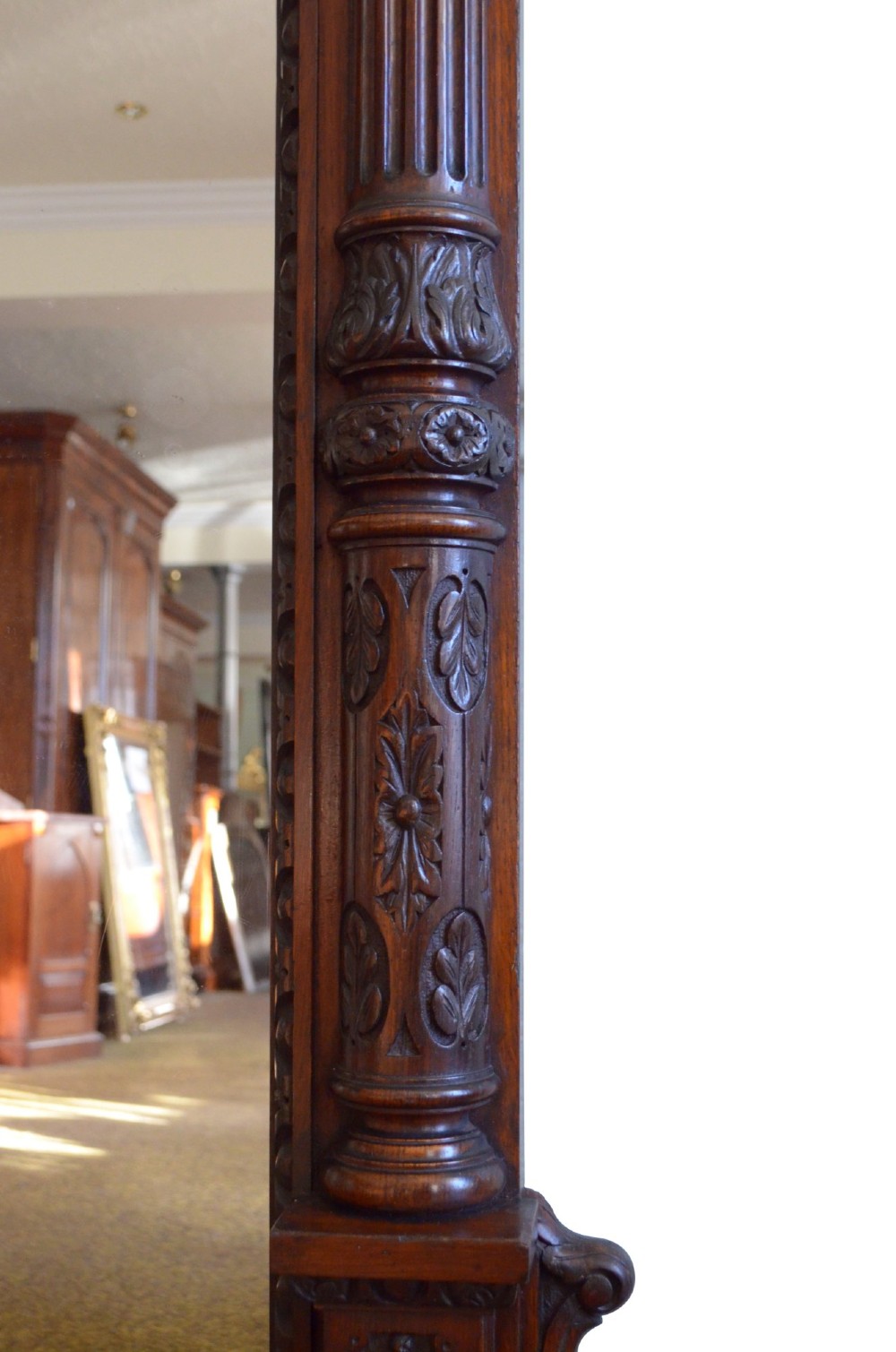 A tall 19th-century English solid oak mirror featuring an arched top, fluted column sides, and detailed hand-carved woodwork. View XV