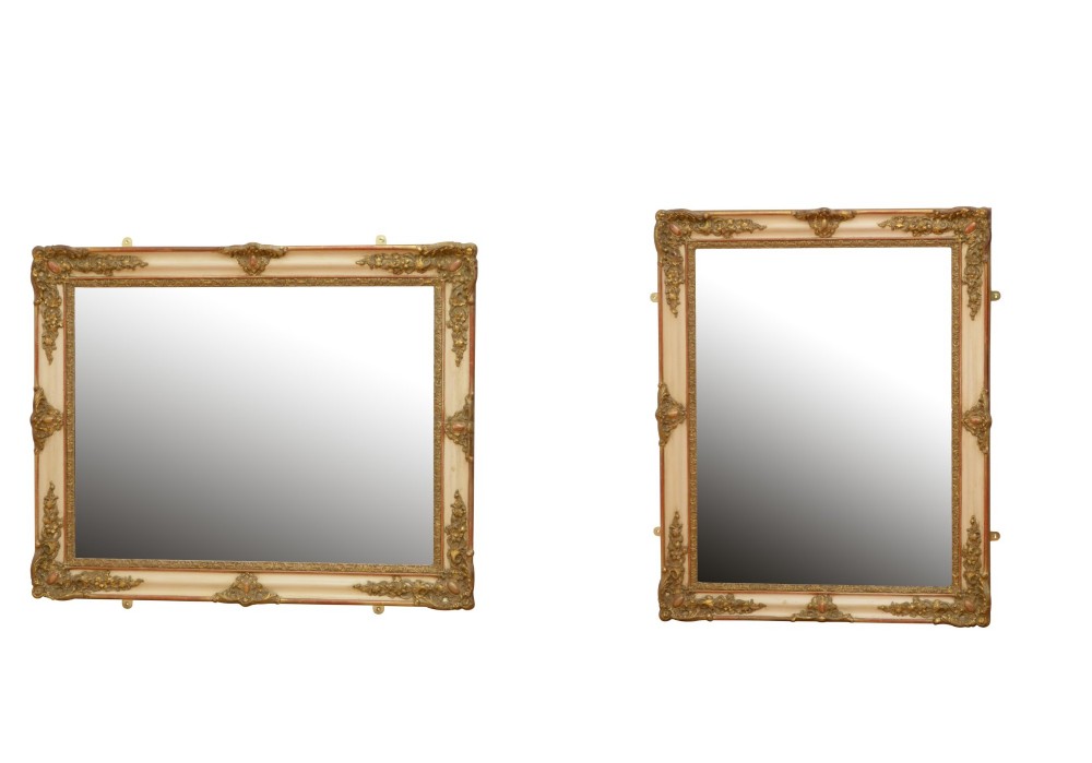 A rectangular 19th-century French Rococo wall mirror featuring an off-white frame decorated with ornate gold gilt gesso scrollwork and corner cartouches surrounding an aged glass plate. View III